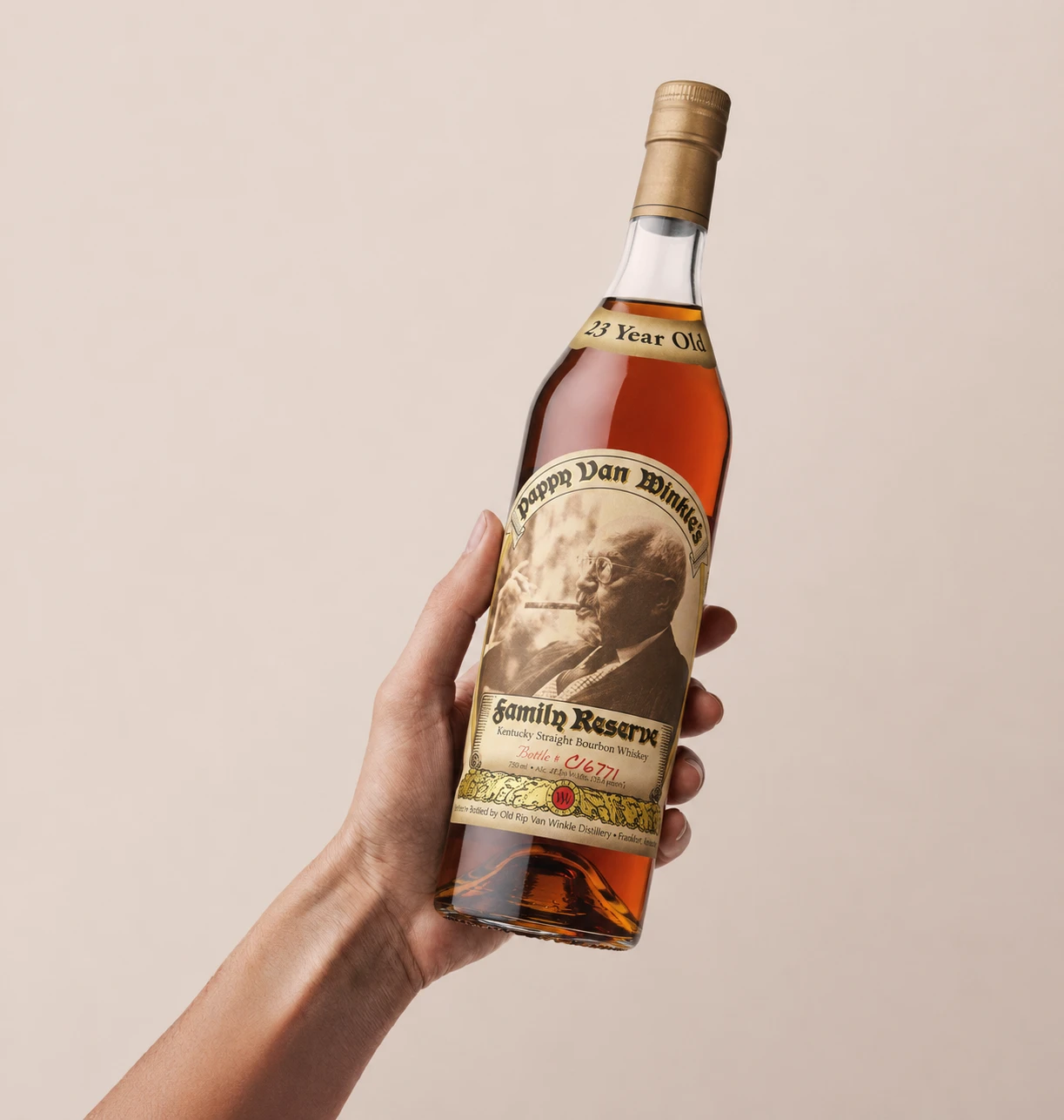A bottle of Pappy Van Winkle's Family Reserve 23 Year, bottle number C16771, held up in hand